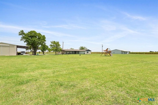 17179 Cyclone Rd, Burlington, TX 76519 - view of green lawn featuring a carport