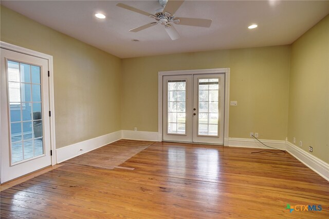 unfurnished room with french doors, ceiling fan, and light hardwood / wood-style flooring