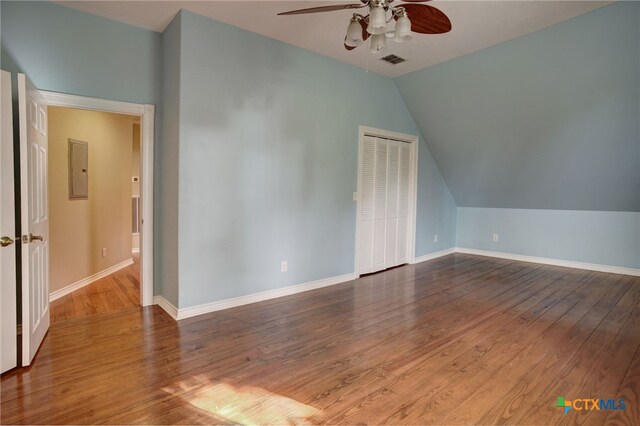 additional living space with electric panel, hardwood / wood-style flooring, ceiling fan, and lofted ceiling