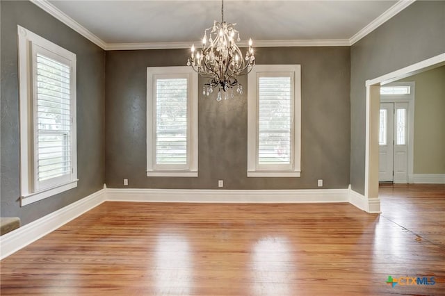 1322 N Ave F Ave, Shiner, TX 77984 - unfurnished dining area featuring light wood-style floors, a chandelier, baseboards, and crown molding