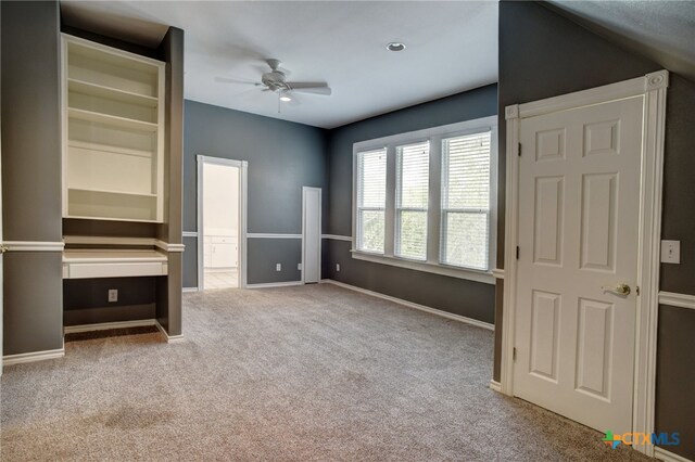 unfurnished bedroom featuring light carpet and ceiling fan