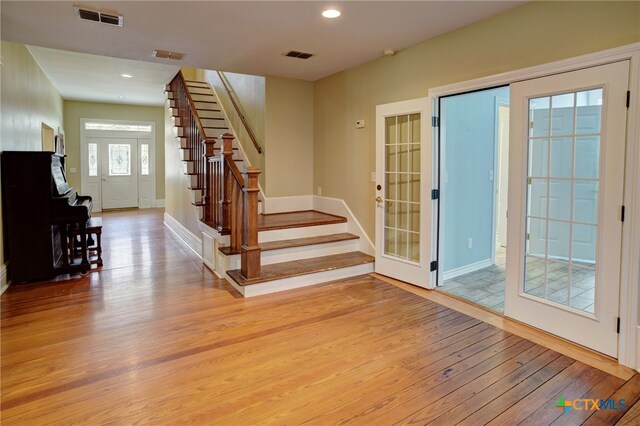 interior space featuring french doors, light hardwood / wood-style floors, and plenty of natural light