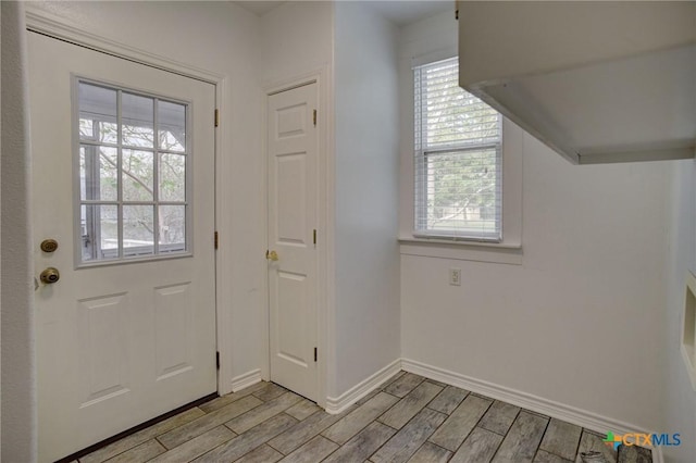 1322 N Ave F Ave, Shiner, TX 77984 - doorway to outside featuring light wood finished floors and baseboards