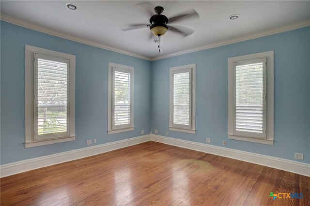 empty room featuring ceiling fan, wood-type flooring, and ornamental molding