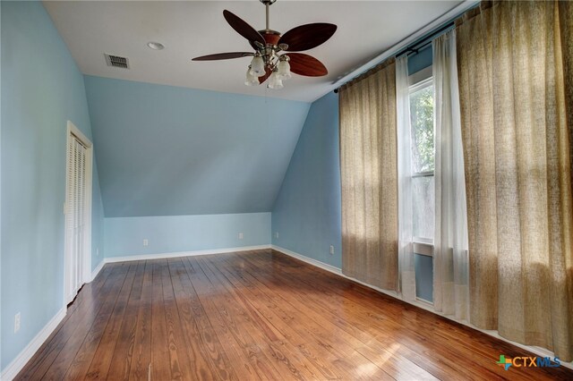 additional living space with lofted ceiling, wood-type flooring, and ceiling fan