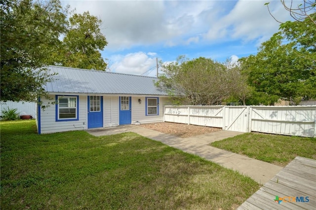 1322 N Ave F Ave, Shiner, TX 77984 - view of front facade with metal roof and a gate