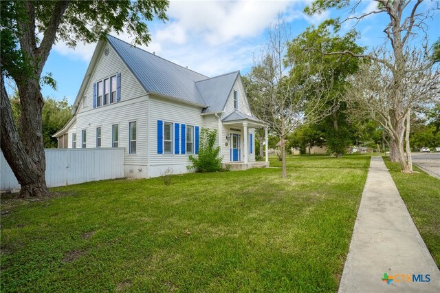 view of side of property with a yard