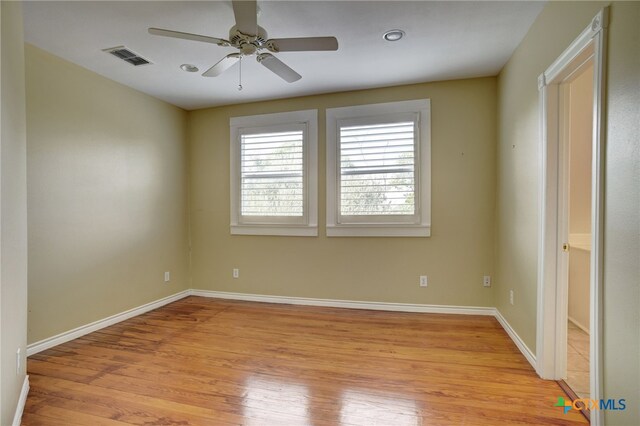 empty room with light wood-type flooring and ceiling fan