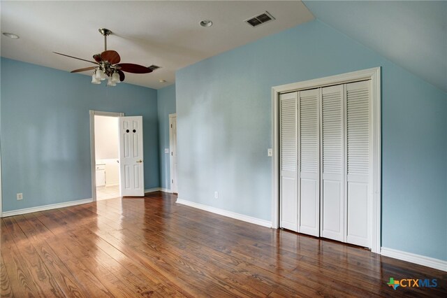 unfurnished bedroom featuring dark wood-type flooring, ceiling fan, and vaulted ceiling