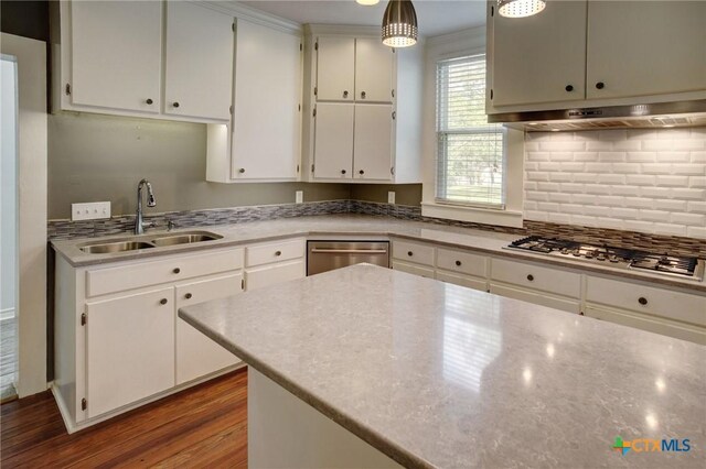 1322 N Ave F Ave, Shiner, TX 77984 - kitchen featuring stainless steel appliances, a sink, backsplash, white cabinets, and under cabinet range hood