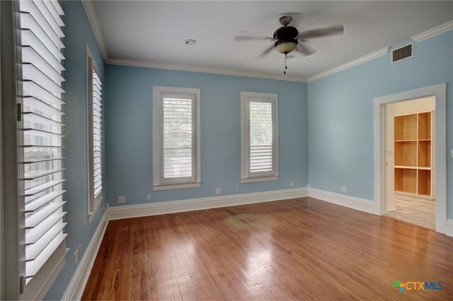 empty room featuring hardwood / wood-style floors, ceiling fan, and crown molding