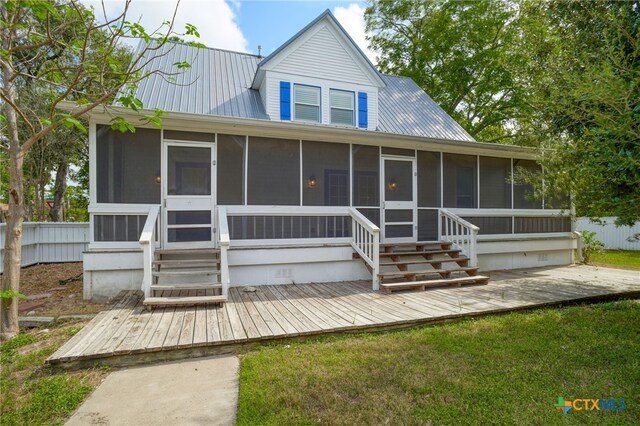 back of house featuring a sunroom and a yard