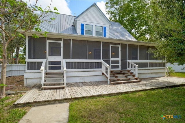 1322 N Ave F Ave, Shiner, TX 77984 - view of front of home featuring a sunroom, a deck, and metal roof