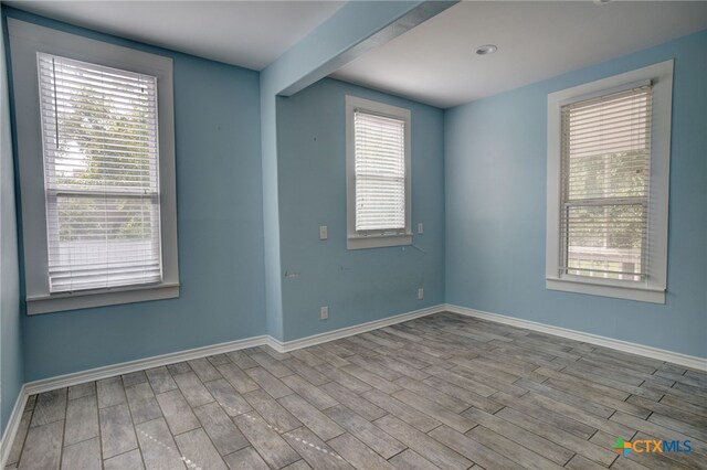 spare room featuring light wood-type flooring