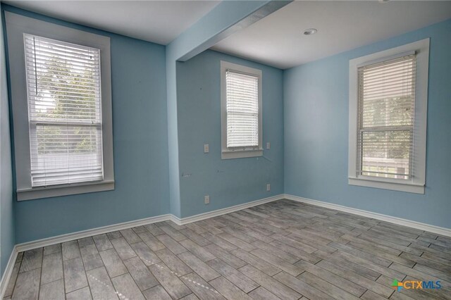1322 N Ave F Ave, Shiner, TX 77984 - spare room featuring wood finished floors and baseboards