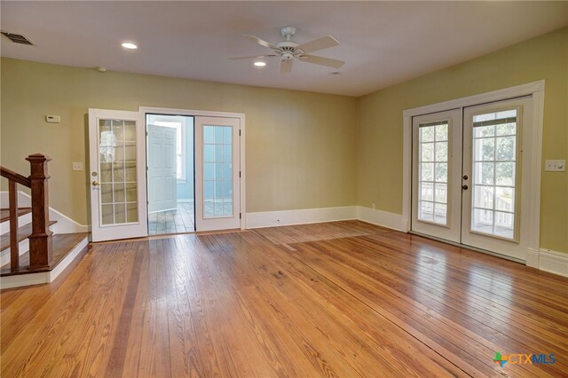 unfurnished room with french doors, ceiling fan, and light wood-type flooring