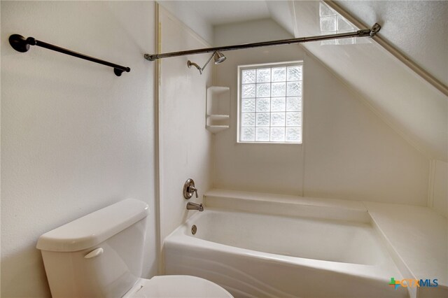 bathroom with bathing tub / shower combination and toilet