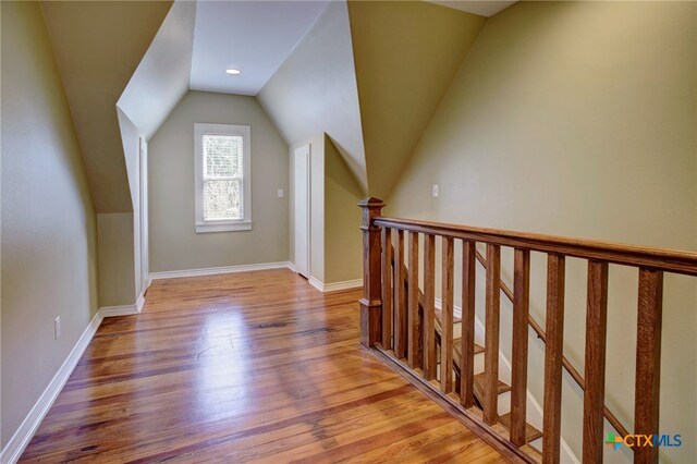 bonus room featuring light wood-type flooring and lofted ceiling