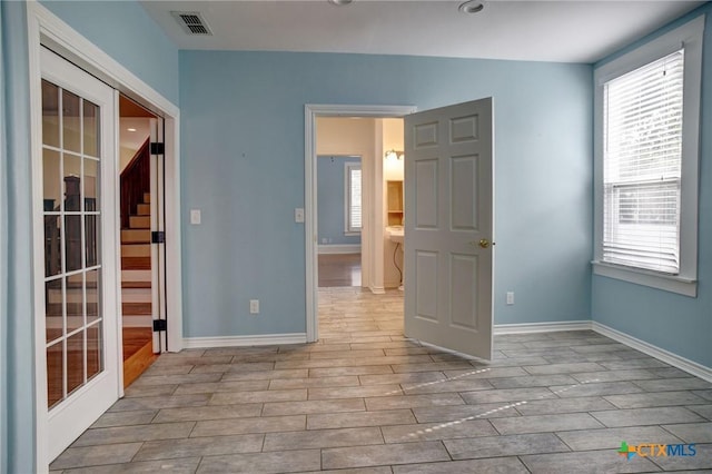 1322 N Ave F Ave, Shiner, TX 77984 - spare room with healthy amount of natural light, wood finished floors, and baseboards