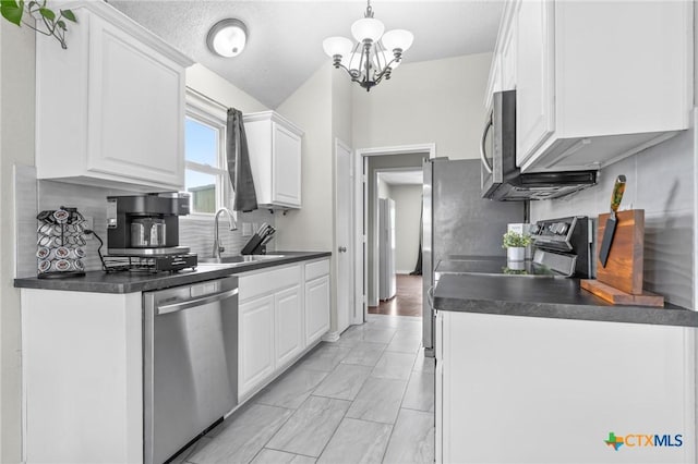 2804 Bluejay Dr, Killeen, TX 76549 - kitchen with appliances with stainless steel finishes, a sink, dark countertops, white cabinets, and a chandelier