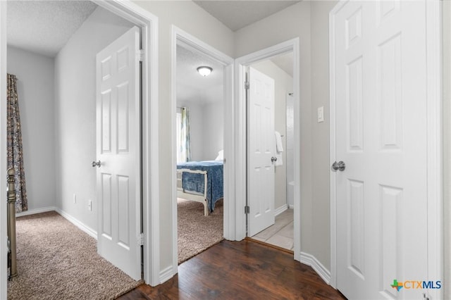2804 Bluejay Dr, Killeen, TX 76549 - hall featuring dark wood finished floors, baseboards, and dark carpet