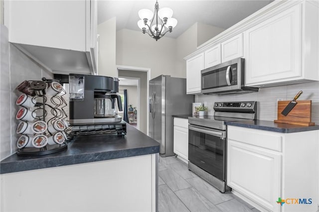 2804 Bluejay Dr, Killeen, TX 76549 - kitchen featuring appliances with stainless steel finishes, dark countertops, light marble finish flooring, white cabinetry, and a chandelier