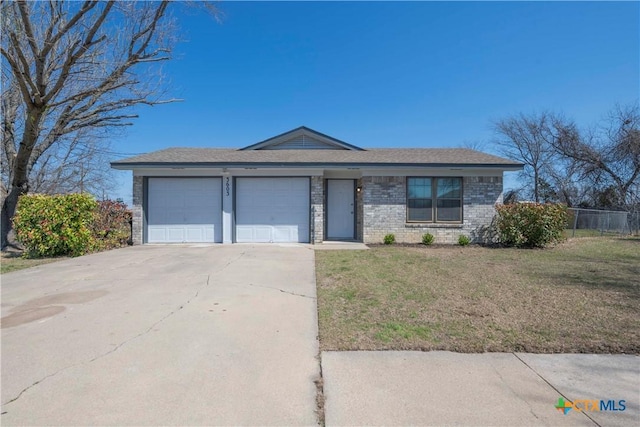 view of front facade featuring fence, driveway, an attached garage, a front lawn, and brick siding