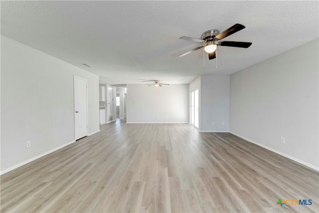 unfurnished living room featuring baseboards, a textured ceiling, ceiling fan, and light wood finished floors