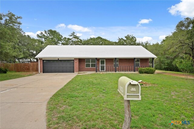 503 Pine St, Smithville, TX 78957 - single story home featuring a garage, driveway, and brick siding