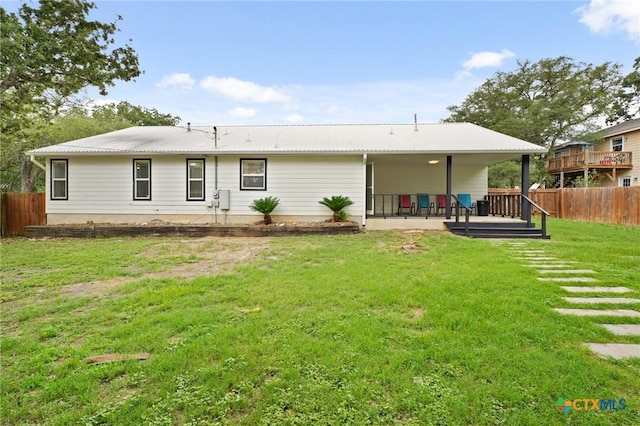 503 Pine St, Smithville, TX 78957 - back of property featuring a metal roof, a deck, and a patio