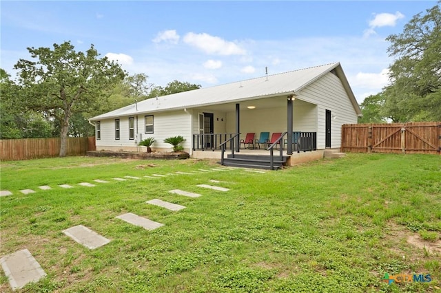 503 Pine St, Smithville, TX 78957 - back of house featuring a gate and a metal roof