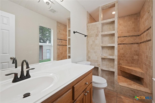 503 Pine St, Smithville, TX 78957 - bathroom with a tile shower, vanity, and tile patterned flooring