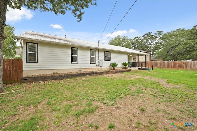 503 Pine St, Smithville, TX 78957 - rear view of house with a metal roof
