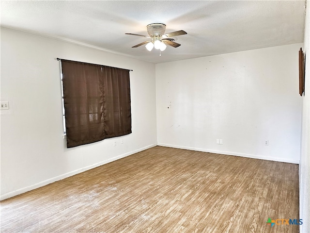 empty room with a textured ceiling, ceiling fan, and light hardwood / wood-style flooring