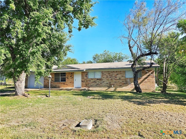 single story home with a front yard and a garage