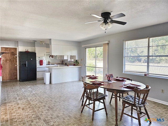 dining area featuring a textured ceiling and ceiling fan