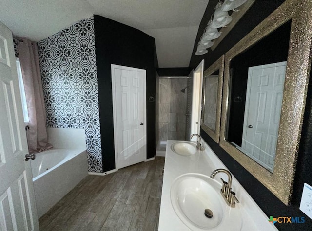 bathroom featuring vanity, independent shower and bath, hardwood / wood-style floors, and a textured ceiling