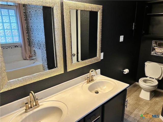 full bathroom featuring hardwood / wood-style flooring, vanity, toilet, and shower / bath combo