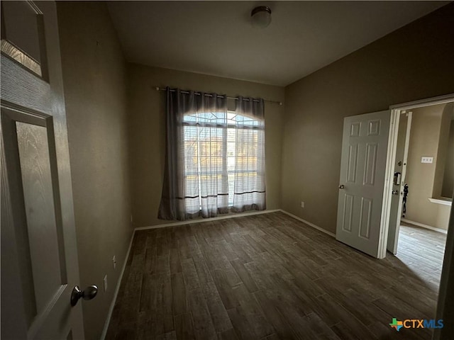 spare room with dark hardwood / wood-style floors