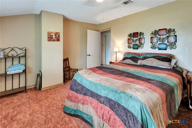 bedroom featuring ceiling fan, a textured ceiling, and carpet