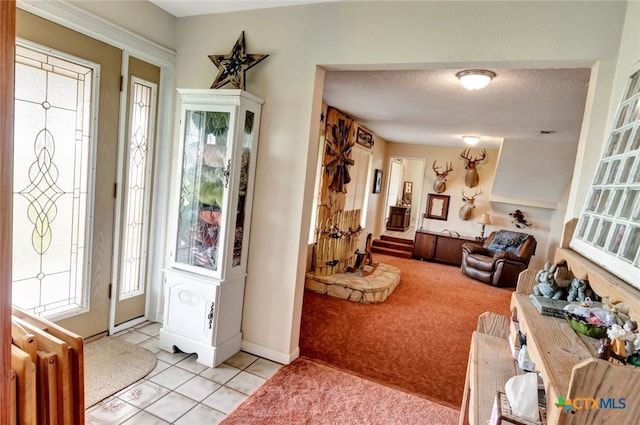 carpeted entryway featuring radiator and a textured ceiling