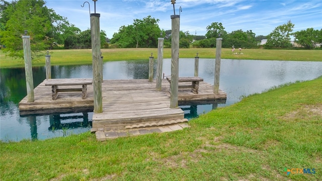 dock area featuring a water view and a lawn