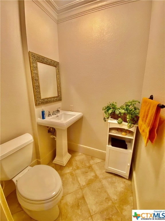 bathroom with toilet and ornamental molding