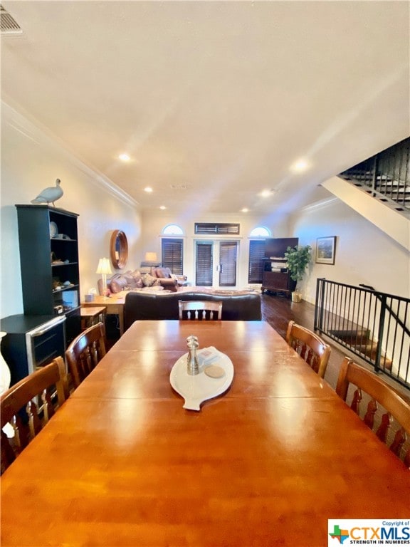 dining room featuring hardwood / wood-style floors and ornamental molding