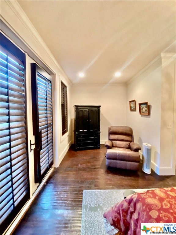 living room featuring ornamental molding and dark hardwood / wood-style floors