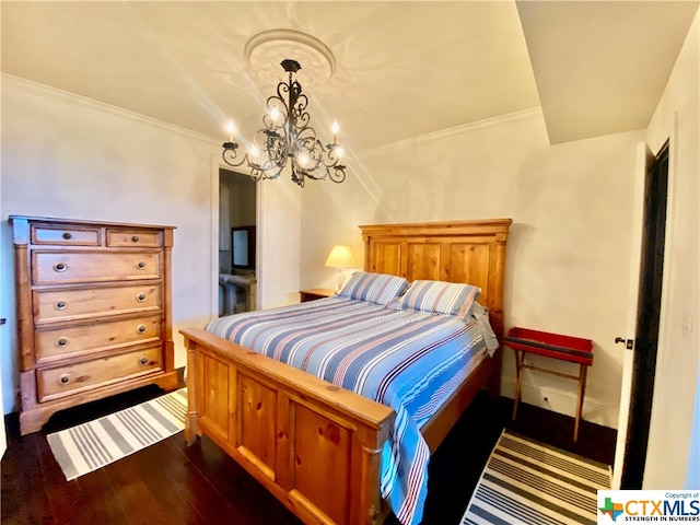 bedroom with dark wood-type flooring, a chandelier, and crown molding