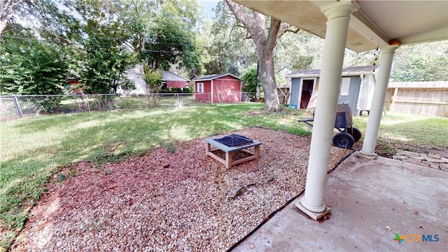 4610 Camellia St, Victoria, TX 77904 - fenced backyard featuring a fire pit and a shed