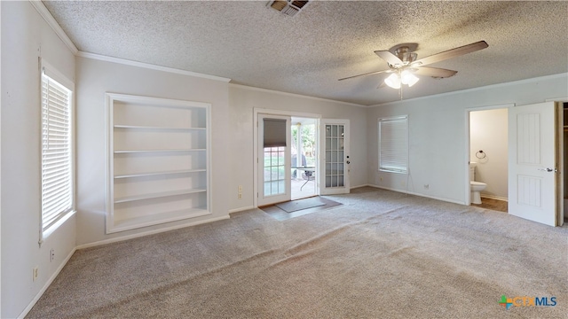 4610 Camellia St, Victoria, TX 77904 - carpeted empty room with a ceiling fan, ornamental molding, a textured ceiling, and french doors