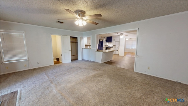 4610 Camellia St, Victoria, TX 77904 - unfurnished living room featuring a ceiling fan, light carpet, crown molding, and a textured ceiling