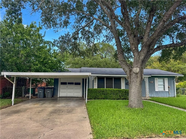 4610 Camellia St, Victoria, TX 77904 - ranch-style home with an attached garage, board and batten siding, driveway, and a carport
